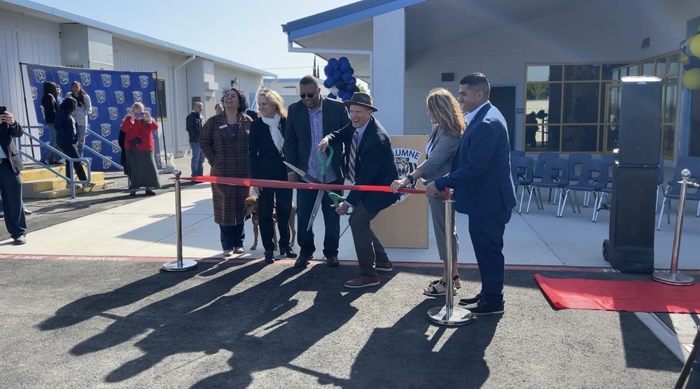 MCS Board Members and District Administrators cut a large ribbon in front of Tuolumne TK-8 School's new Sustainable Structures.