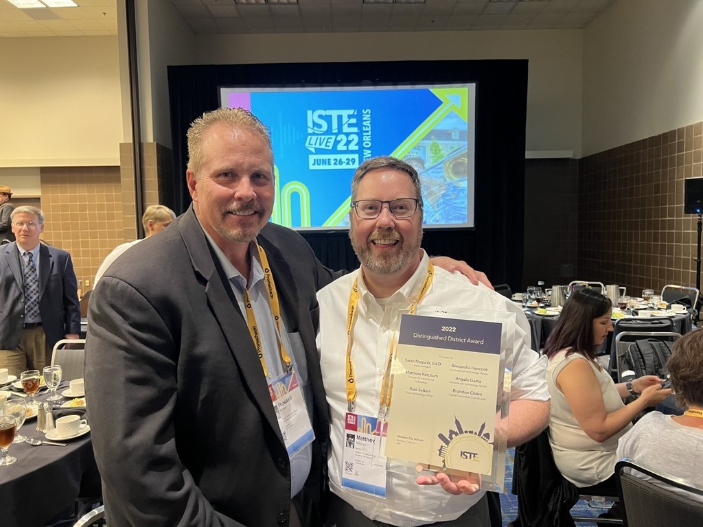CTO Russ Selken and Director of Educational Technology Matthew Ketchum holding up the ISTE Distinguished District Award